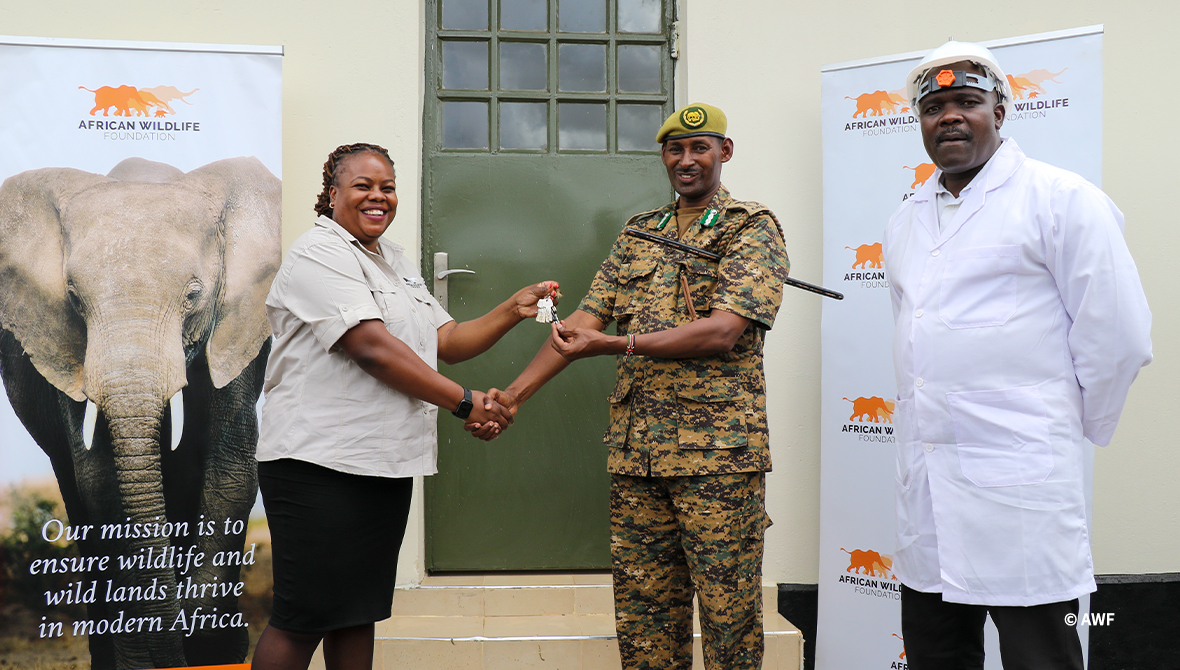 AWF and KWS shake hands in front of an evidence room.