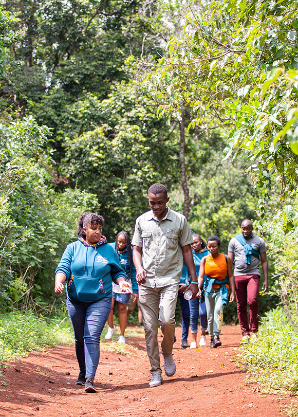 Youth walking on a forest path.