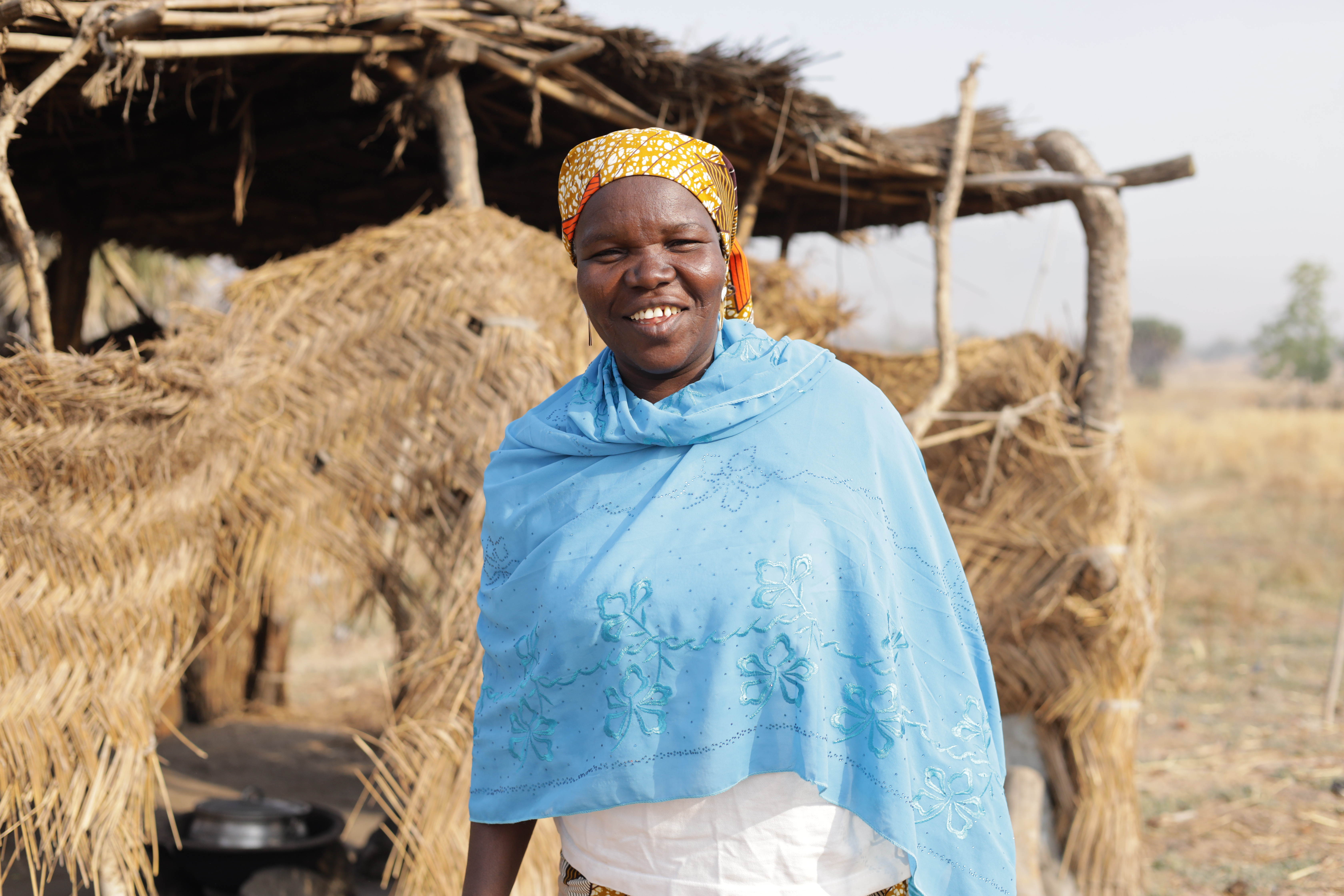 Hauoa Laraba stands infront of her kitchen in tchamba, Faro Landscape