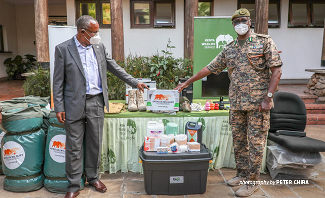 Photo of Dr Philip Muruthi handing over equipment for AWF-supported Lake Nakuru National Park KWS Canine Unit